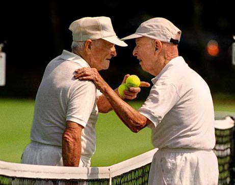 two elderly tennis players meeting at the net for a lively discussion. Exercise for elderly. Activities for elderly.