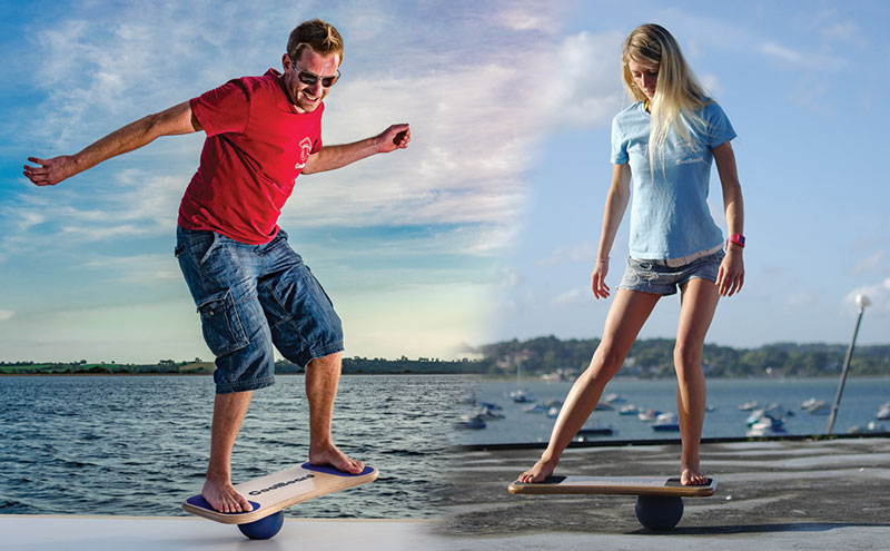 man enjoying dynamic balance training and woman using CoolBoard balance board on the ball