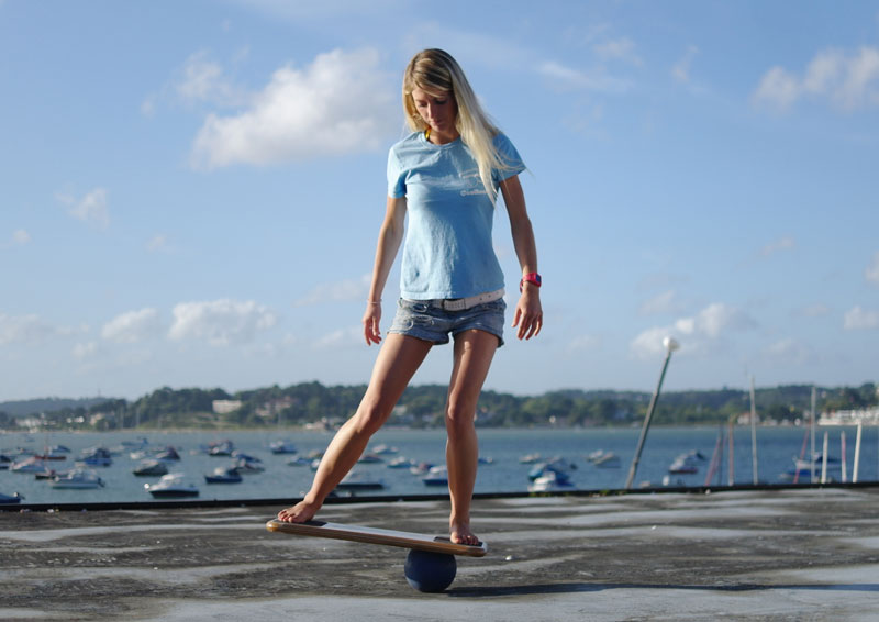 woman on coolboard balance board on the ball