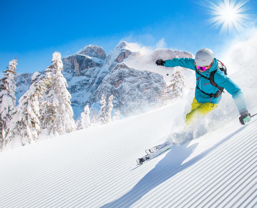 image of skier skiing down pristine ski run