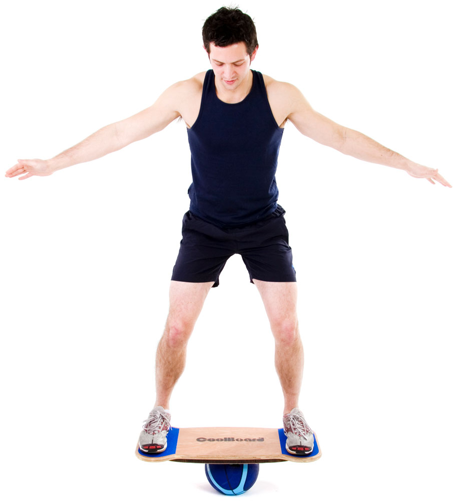 man in gym clothes riding coolboard balance board in very balanced way